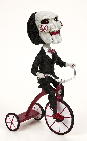 SAW PUPPET ON TRICYCLE HEADKNOCKER